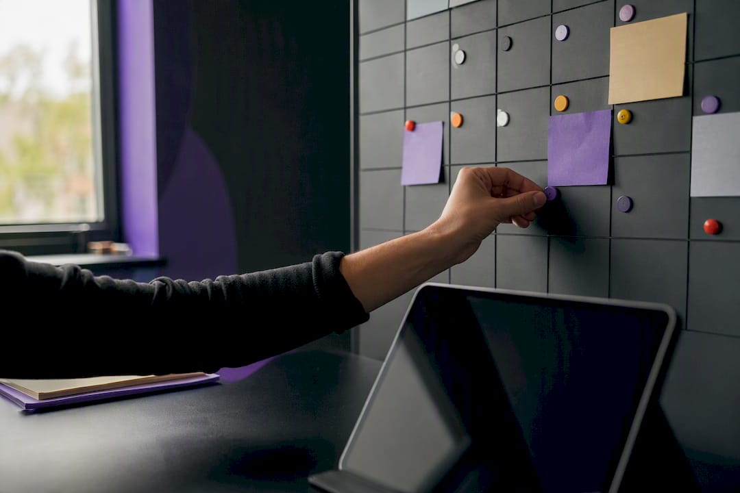 Hand placing token near dim tablet calendar